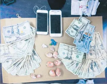  ?? Photograph­s by Myung J. Chun Los Angeles Times ?? A TEAM of sheriff ’s detectives working out of the Santa Clarita Valley station arrested 39 people on suspicion of narcotics possession and sales. They also seized two pounds of heroin, $13,000 in cash and a stolen weapon.