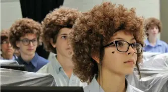  ?? AP ?? HEADS OF THE CLASS: Art students at Madison Middle School in Abilene, Texas, wear wigs Thursday in tribute to the late painter Bob Ross.