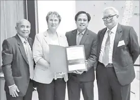  ??  ?? Photo shows (from left) Landbank director Crispino Aguelo, executive vice president Rabboni Francis Arjonillo, and director Victor Gerardo Bulatao receive the Certificat­e of Merit from Karlsruhe Mayor Gabriele Luczak-Schwarz.