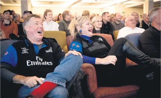  ?? Pictures / Dean Purcell ?? Malcolm Scott and Suzie Bosher watch the America’s Cup showdown with glee at the Royal New Zealand Yacht Squadron yesterday.