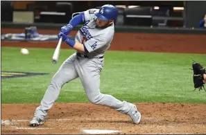  ?? WALLY SKALIJ/LOS ANGELES TIMES ?? The Dodgers' Max Muncy hits a two-run single against the Rays in the third inning in Game 3 of the World Series on Friday.