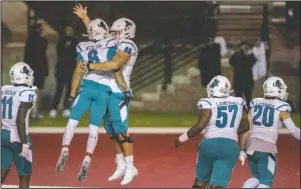  ?? The Associated Press ?? CELEBRATIN­G A SEASON: Coastal Carolina wide receiver Jaivon Heiligh (6) and teammate Will McDonald (66) celebrate Heiligh’s touchdown against Troy during the second half of Saturday’s game in Troy, Ala.