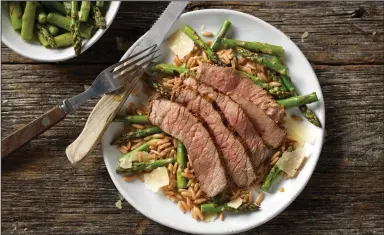  ?? Courtesy of Cattlemen’s Beef Board ?? Grilled Top Round Steak With Parmesan Asparagus