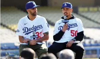  ?? GETTY IMAGES ?? VICTOR GO SOILS: Dodgers outfielder Mookie Betts, right, and pitcher David Price are introduced at Dodger Stadium on Wednesday in Los Angeles.