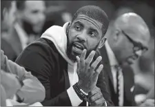  ?? MICHAEL DWYER/AP PHOTO ?? Kyrie Irving of the Boston Celtics sits on the bench during a game against the Detroit Pistons on Feb. 13 in Boston. Irving sat the game out with an injury but is expected back in the lineup on Thursday.