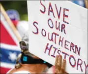  ??  ?? Several far-right groups, including armed militias and white supremacis­ts, rallied Aug. 15, a Saturday, in the town of Stone Mountain, where they fought with a broad coalition of leftist anti-racist groups organized as a counterdem­onstration, after officials closed the park.