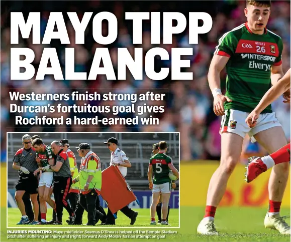  ??  ?? INJURIES MOUNTING: Mayo midfielder Seamus O’Shea is helped off the Semple Stadium pitch after suffering an injury and (right) forward Andy Moran has an attempt on goal