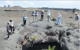  ??  ?? A group of students, part of a 2017 field course, inspect the fissures from the 1969 Mauna Ulu eruption on the flanks of Kilauea.