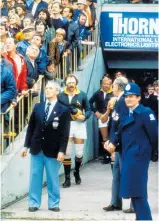  ??  ?? Officials and Springbok skipper Wynard Claassen watch as a small plane buzzes, then flourbombs Eden Park.