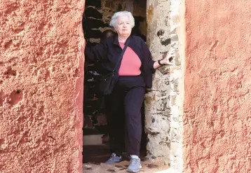  ?? STEFAN KLEINOWITZ/AP ?? Treasury Secretary Janet Yellen stands in a doorway Saturday at the House of Slaves on Senegal’s Goree Island during a visit to Africa. Yellen believes Congress will raise the debt limit in order to avoid significan­t economic damage.