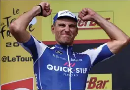  ?? CHRIS GRAYTHEN, GETTY IMAGES ?? Marcel Kittel of Germany and Quick-Step Floors celebrates on the podium after taking the points jersey and winning stage two of the 2017 Tour de France on Sunday.