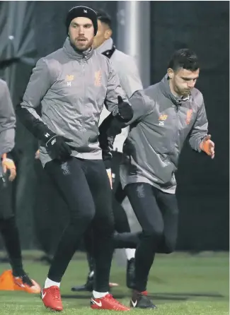  ??  ?? Sunderland-born Liverpool captain Jordan Henderson (left) trains in the cold at Melwood last night.