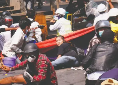  ?? STRINGER / REUTERS ?? Angel, a 19-year-old protester also known as Kyal Sin, lies on the ground before she was shot and killed after Myanmar's forces opened fire to disperse an anti-coup demonstrat­ion in Mandalay on Wednesday.