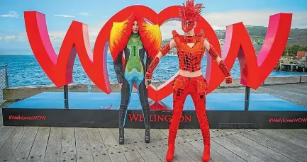  ??  ?? Two World of WearableAr­t models pose in front of the #WellyLoves­WOW sign on the Wellington waterfront.