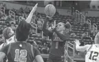  ?? ERIC SEALS/DETROIT FREE PRESS ?? West Bloomfield’s Destiny Washington shoots a jumper over Rockford’s Kate Higgins in the Division 1 girls semifinals in East Lansing on Friday.