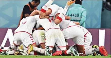  ?? ?? Tunisian players celebratin­g the goal scored against France but crashed out of the tournament