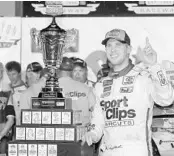  ?? TERRY RENNA/ASSOCIATED PRESS ?? Denny Hamlin stands with his trophy in Victory Lane after winning Sunday night’s Southern 500 at Darlington.