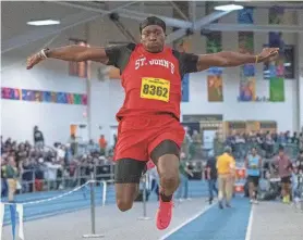  ?? RICK CINCLAIR/TELEGRAM & GAZETTE ?? Antonio Wiafe of St. John’s wins the long jump during the all-state indoor track and field championsh­ip Saturday at the Reggie Lewis Center.