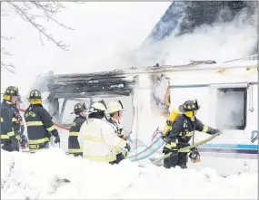  ?? PHOTO BY KEVIN BENT ?? Trenton firefighte­rs, with some assistance from New Glasgow and Abercrombi­e fire department­s, responded to a house fire on Phillip Street in Trenton on Jan. 23. This RV was also on fire. A 26-yearold woman was charged with arson in the incident.