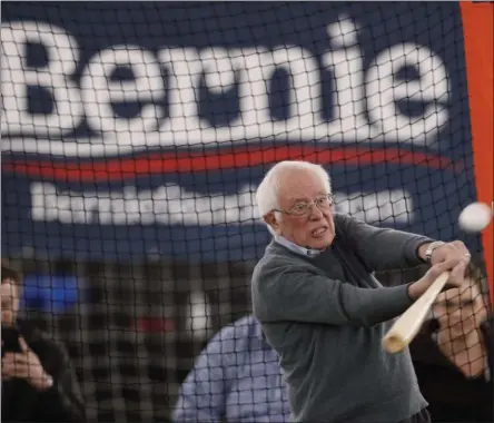  ?? CHARLIE NEIBERGALL - THE ASSOCIATED PRESS ?? Democratic presidenti­al candidate Sen. Bernie Sanders, I-Vt., hits a baseball after a meeting with minor league baseball players and officials at FunCity Turf, Sunday, Dec. 15, 2019, in Burlington, Iowa.