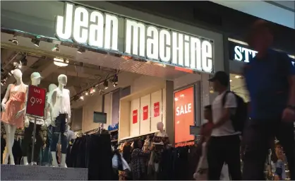  ?? CP PHOTO ?? A Jean Machine storefront is shown in Toronto on Wednesday. Four months after acquiring Jean Machine, the new owner of the denim retailer says it plans on “cleaning up” the look of its stores as part of an effort to woo back customers.