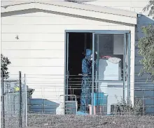  ?? RICHARD WAINWRIGHT THE ASSOCIATED PRESS ?? Police forensics investigat­e the death of seven people in a suspected murder-suicide in Osmington, Australia, on Friday.