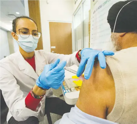  ?? ARLEN REDEKOP ?? Anastasia Besiou of Wellness Pharmacy Surrey administer­s a vaccine shot on Tuesday.