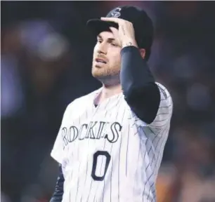  ??  ?? Rockies relief pitcher Adam Ottavino reacts to giving up a solo home run to Brewers slugger Chris Carter in the 10th inning Saturday night. David Zalubowski, The Associated Press