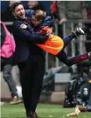  ??  ?? Bristol City boss Lee Johnson celebrates with a ballboy