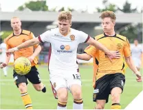  ??  ?? Motherwell’s Chris Cadden shields the ball.