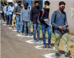  ?? PTI ?? Applicants stand in queue as they arrive to appear for the National Defence Academy and Naval Academy exams in Prayagraj on Sunday. —