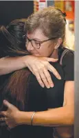  ??  ?? DISTRESSED: TSG store workers Amiria Little and Sharyn Charman hug during the cleanup of the store.