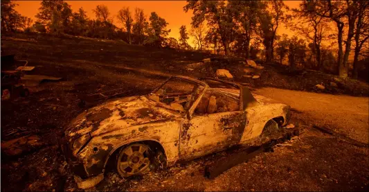  ?? AP PhoTo/NoAh Berger ?? In this July 27 file photo, cars scorched by the Carr Fire rest at a residence in Redding, Calif.