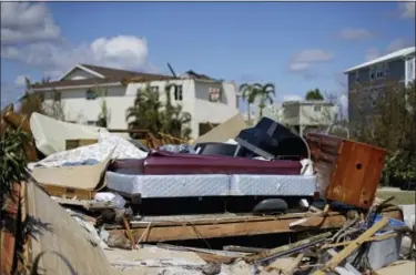  ?? DAVID GOLDMAN — THE ASSOCIATED PRESS ?? A bed sits amongst the remains of its room in a home demolished from Hurricane Irma in Goodland, Fla., Tuesday.