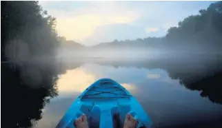  ??  ?? A thin mist rises over the Wacissa River during an evening kayak paddle in North Florida.