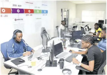  ?? (Photos: Joseph Wellington) ?? Employees at the Amber Group at its headquarte­rs in St Andrew, Jamaica