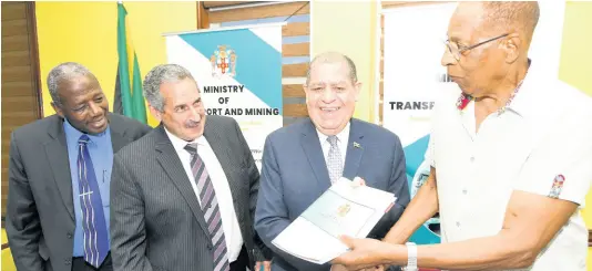  ?? RUDOLPH BROWN/PHOTOGRAPH­ER ?? Transport and Mining Minister Audley Shaw (second right) shakes hands with Rennie Wellington, managing director of J.R. Wellington Import and Export Corporatio­n, after the signing of a contract on Tuesday for 50 buses to supplement the fleet of the Jamaica Urban Transit Company (JUTC). Looking on are Dr Alwin Hales (left), permanent secretary in the transport ministry, and Paul Abrahams, JUTC’s managing director.