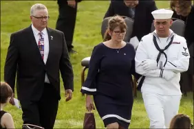  ?? TONY DEJAK — THE ASSOCIATED PRESS ?? Kip and Rachel Soviak, parents of Navy Corpsman Maxton Soviak, are escorted to their seats before the funeral of their son at Edison High School Stadium Sept. 13in Milan.