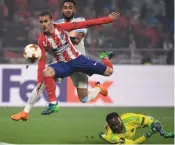  ?? — AFP ?? Antoine Griezmann ( centre) scores on Wednesday.