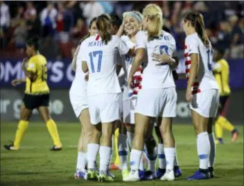  ?? ANDY JACOBSOHN — THE ASSOCIATED PRESS ?? Teammates celebrate after United States midfielder Julie Ertz (facing camera) scored a goal during the first half of a CONCACAF World Cup qualifying semifinal in Frisco, Texas, Sunday. The U.S. scored five times in the first half of a 6-0 win over Jamaica.