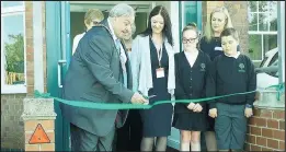  ??  ?? The new Hinckley Parks Primary School has officially opened on the old Mount Grace site in Leicester Road Hinckley following the transfer of Holliers Walk pupils and teachers. Leicesters­hire County Council Chairman Bill Liqourish cuts the ribbon.