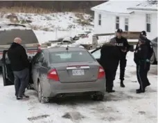  ?? LARS HAGBERG/THE CANADIAN PRESS ?? Toronto police forensic officers stand outside a house in Madoc, Ont. They released it, and two others, back to owners on Tuesday.
