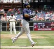  ?? MATT SLOCUM — THE ASSOCIATED PRESS ?? Milwaukee Brewers’ Jesus Aguilar, right, rounds the bases after hitting a two-run home run off Philadelph­ia Phillies starting pitcher Jake Arrieta, left, during the first inning of a baseball game, Saturday.