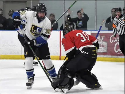  ?? PHOTOS BY DAVID DALTON — FOR MEDIANEWS GROUP ?? Donald Gooley of L’Anse Creuse Unified tries to get control of the puck near the Romeo net during a MAC Red game at Mount Clemens Ice Arena.