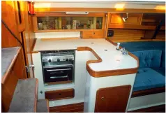  ??  ?? LEFT Positioned almost mid-length in the hull, the galley is near the point of maximum beam, next to the companionw­ay and close to the centre of pitch
