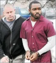  ?? DIGITAL FIRST MEDIA FILE PHOTO ?? Daquan Hamilton is led into district court on Feb. 21, 2014, for a preliminar­y hearing accused of killing a Pottstown man in December 2013.