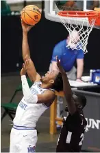  ?? AP Photo/Tony Gutierrez
after halftime ?? ■ Memphis forward DeAndre Williams, left, throws up a shot as Mississipp­i State forward Abdul Ado, right, defends in the second half of an NCAA college basketball championsh­ip game in the NIT on Sunday in Frisco, Texas. halftime buzzer.
The Tigers then shot 67%