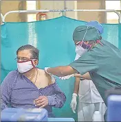  ?? ?? A health worker vaccinates a beneficiar­y on Tuesday.