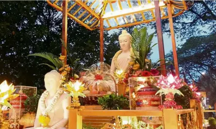 ?? — KAREN BOK/The Star ?? A float with representa­tions of the Buddha decorated with lotus-shaped lights during a Wesak Day celebratio­n last year.