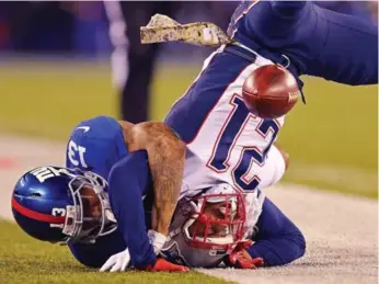  ?? ELSA/GETTY IMAGES ?? The Patriots’ Malcolm Butler, 21, breaks up a pass intended for the Giants’ Odell Beckham. The Pats won 27-26.